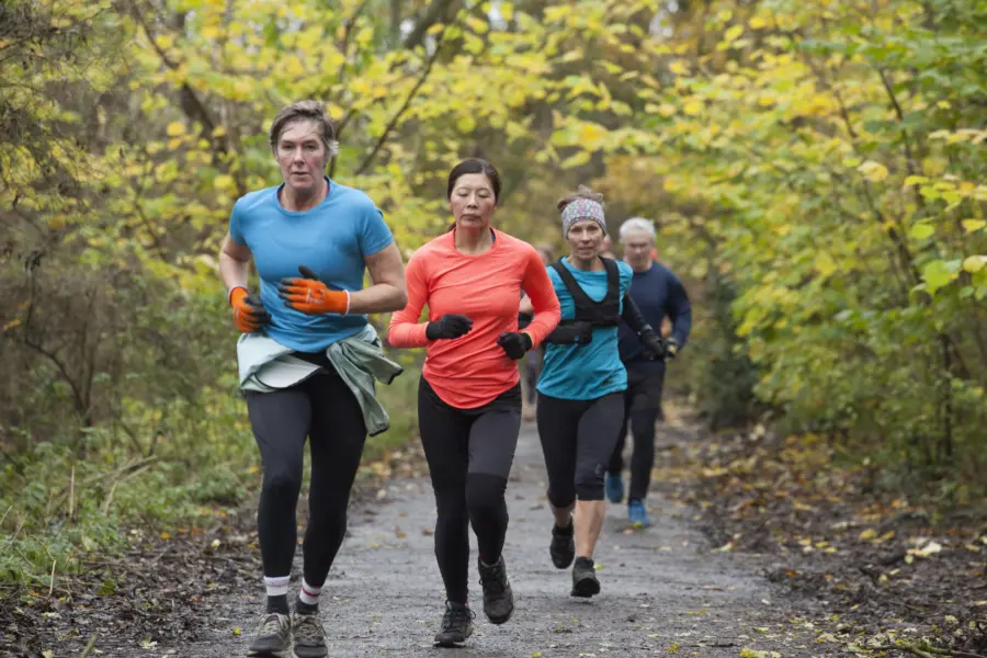 Group of four adults jogging together on a forest 2025 04 05 05 59 36 utc